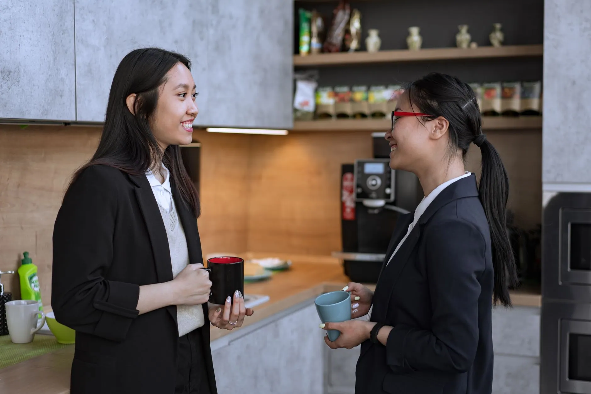 Two colleagues talking over coffee